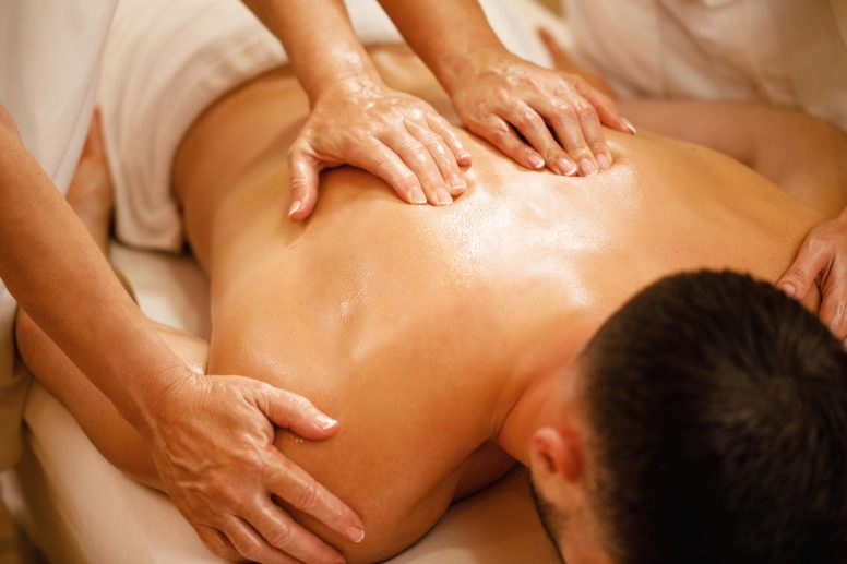 closeup-man-having-back-massage-by-two-therapists-spa